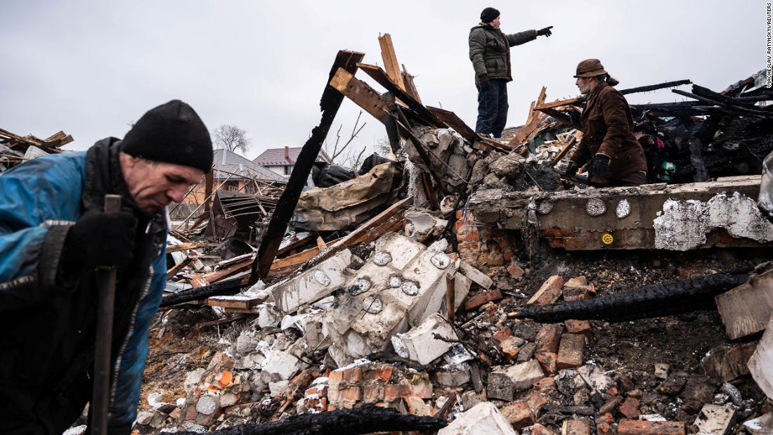Residents of Zhytomyr work in the remains of a residential building on March 2. The building was destroyed by shelling.