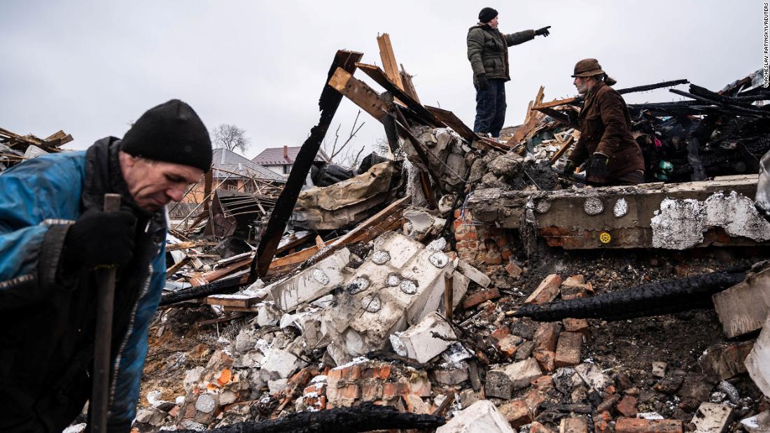 Residents of Zhytomyr, Ukraine, work in the remains of a residential building on March 2. The building was destroyed by shelling.