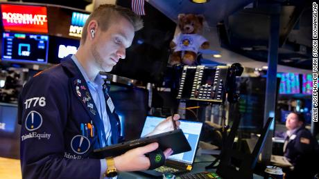 In this photo provided by the New York Stock Exchange, trader Colby Nelson works on the floor, Monday, Feb 28, 2022. Markets quivered Monday amid worries about how high oil prices will go and how badly the global economy will get hit after the U.S. and allies upped the financial pressure on Russia for its invasion of Ukraine. 