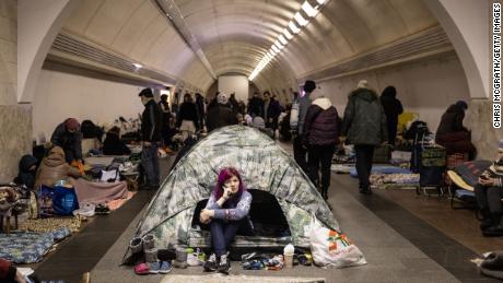 A woman sits in a tent as people take shelter at the Dorohozhichi metro station in Kyiv on Wednesday. 