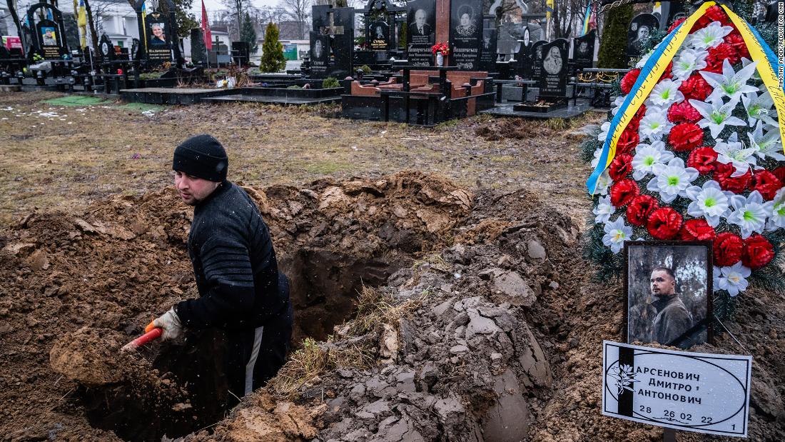 A cemetery worker digs graves for Ukrainian soldiers in Kyiv on March 3.