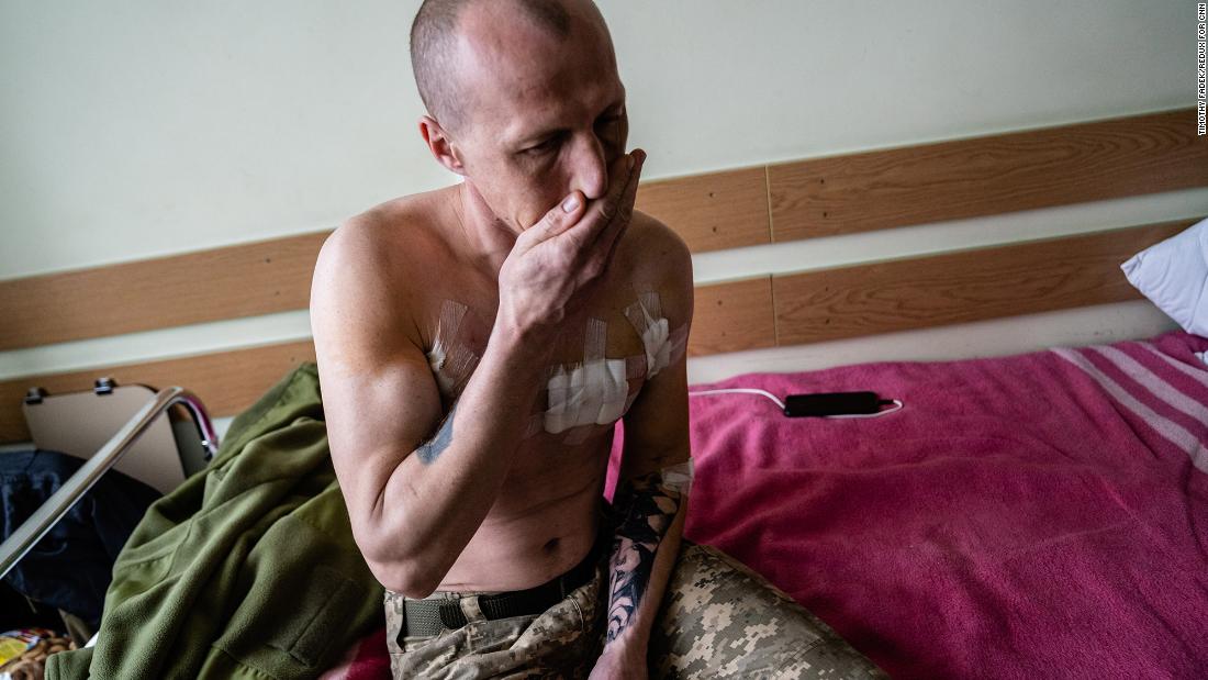 A Ukrainian soldier who says he was shot three times in the opening days of the invasion sits on a hospital bed in Kyiv on March 3.