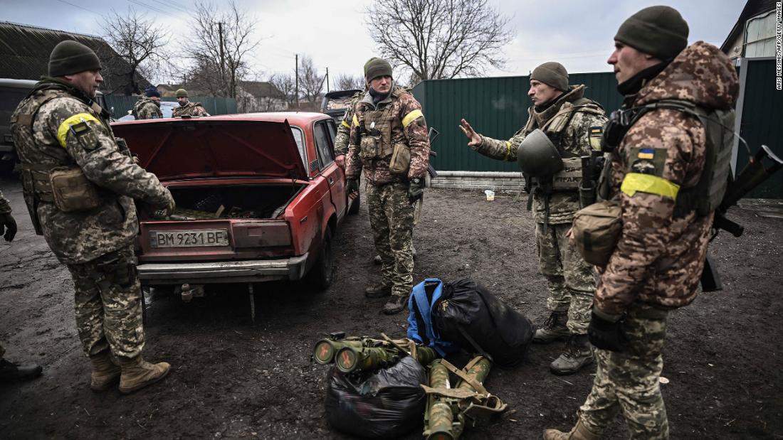 Ukrainian soldiers unload weapons from the trunk of a car northeast of Kyiv on March 3.