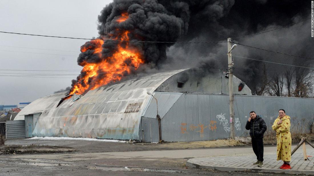 Residents react in front of a burning building after shelling in Kharkiv, Ukraine, on March 3.