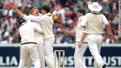 Warne celebrates with his teammates after taking Sachin Tendulkar wicket in 1999.