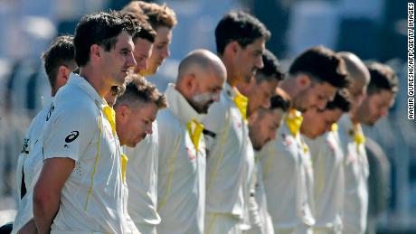 Australia&#39;s players observe a minute silence to pay tribute to Marsh before the start of the first day play of the first Test match between Pakistan and Australia on March 4.