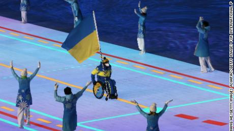 Flag bearer Maksym Yarovyi leads the Ukrainian team during the opening ceremony of the Beijing 2022 Paralympic Winter Games.