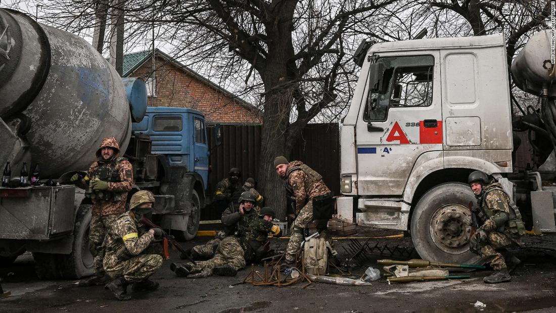 Ukrainian servicemen take cover from shelling in the city of Bucha, west of Kyiv, on March 4.