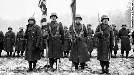 Members of the Japanese-American 442nd Infantry Regiment stand at attention as their quotes are read in France, November 12, 1944, during World War II.