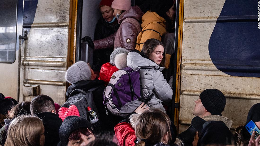 People crowd on a platform as they try to board a westbound train in Kyiv on March 4.