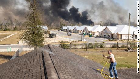 David Watson climbed to the roof of his home  to keep embers from igniting a fire.
