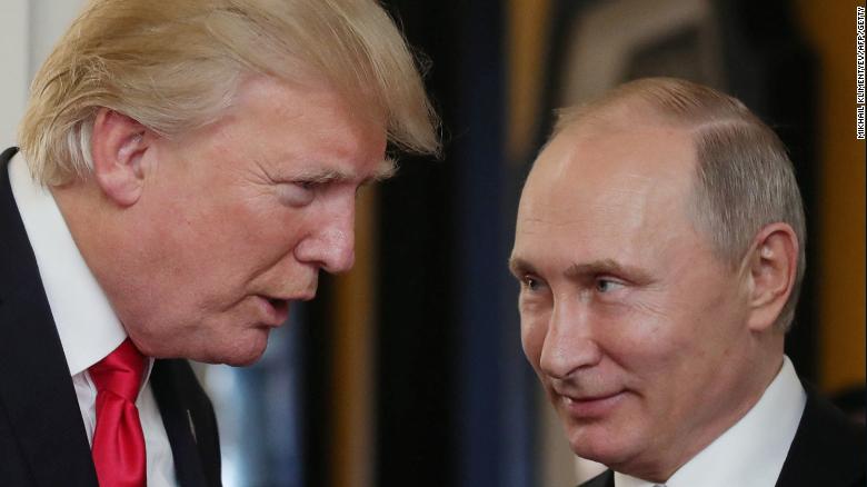 US President Donald Trump chats with Russian President Vladimir Putin in Danang, Vietnam, on November 11, 2017, as they attend the APEC leaders' summit.