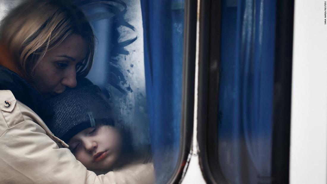 Ukrainian refugees are seen through a bus window as they arrive at a temporary accommodation center in Korczowa, Poland, on March 5.