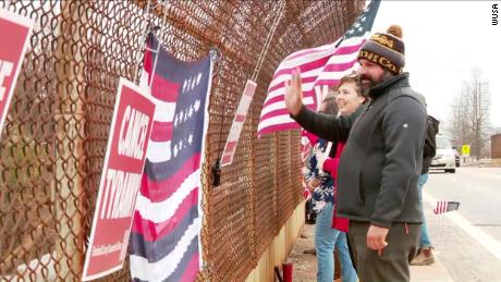 Community members in Hagerstown, Maryland, wave to a trucker convoy passing beneath an overpass on I-70 headed to Washington, DC on Sunday, March 6.