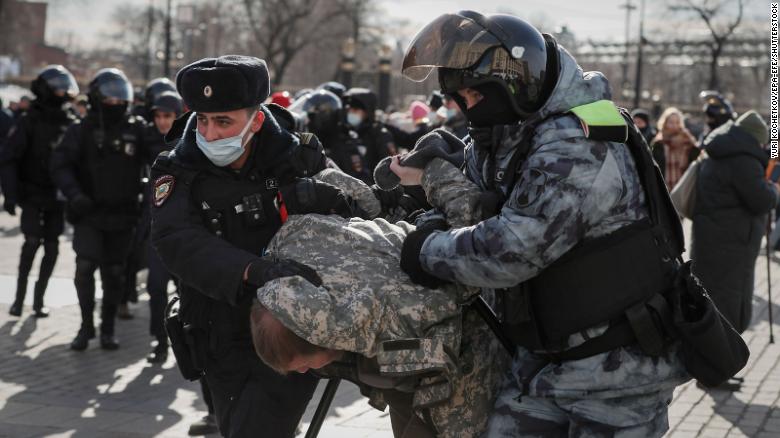 Russian police detain a protester in downtown Moscow on March 6.