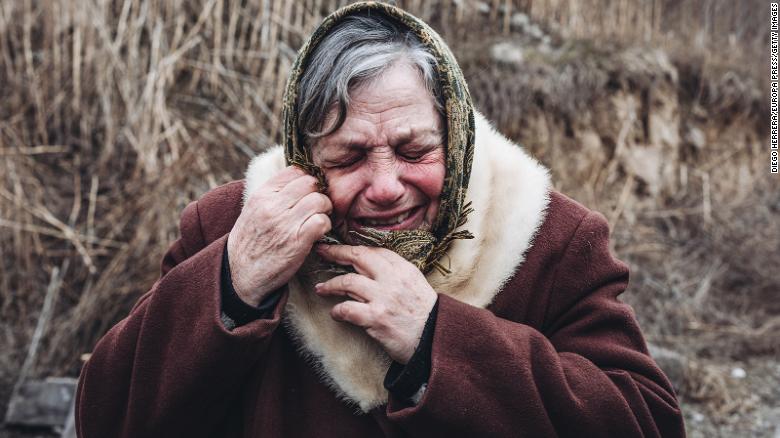 A woman cries as she hears shelling Sunday, March 6, after evacuating the Ukrainian village of Stoyanka.