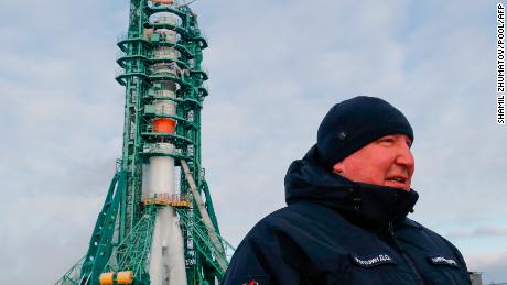 The head of Russia&#39;s Roscosmos space agency, Dmitry Rogozin, stands in front of the Soyuz MS-20 spacecraft at the Baikonur cosmodrome on December 8, 2021. 