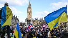 Demonstrators hold placards, Ukrainian and British flags during a protest rally for a Stop the War in Ukraine Global Day of Action, in central London, on March 6, 2022 as part of an international day of anti-war action, prompted by Russia&#39;s invasion of Ukraine. - Ukraine&#39;s President Zelensky has urged foreigners to head to Ukrainian embassies worldwide to sign up for an &quot;international brigade&quot; of volunteers to help fight invading Russian forces. He previously called on foreigners with combat experience to come to help defend his country, which has come under a withering Russian military assault from three sides since February 24. (Photo by JUSTIN TALLIS / AFP) (Photo by JUSTIN TALLIS/AFP via Getty Images)