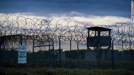 In this photo reviewed by US military officials, the sun sets behind the closed Camp X-Ray detention facility, on April 17, 2019, in Guantanamo Bay Naval Base, Cuba. 