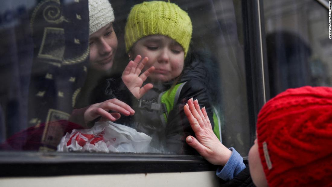 Alexandra, 12, holds her 6-year-old sister, Esyea, who cries as she waves at her mother, Irina, on Monday, March 7. The children were leaving Odessa, Ukraine.