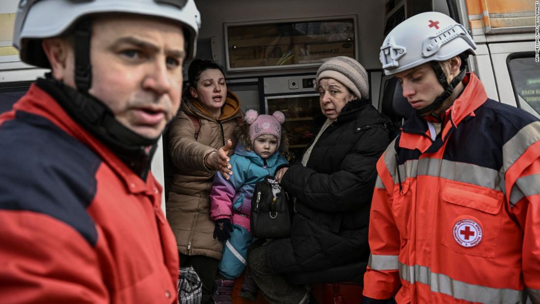 Members of the Red Cross help people fleeing the Kyiv suburb of Irpin on March 7.