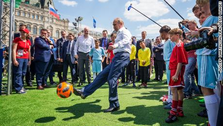 Vladimir Putin hits football during an event on June 28, 2018 in Red Square in Moscow.