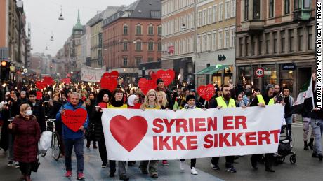 Demonstrators march with a banner reading &quot;Syria is not safe&quot; during a protest against the government&#39;s policy of returning some Syrian refugees in Copenhagen on November 13, 2021.