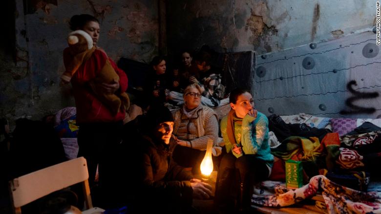 People huddle in a bomb shelter in Mariupol on Sunday.