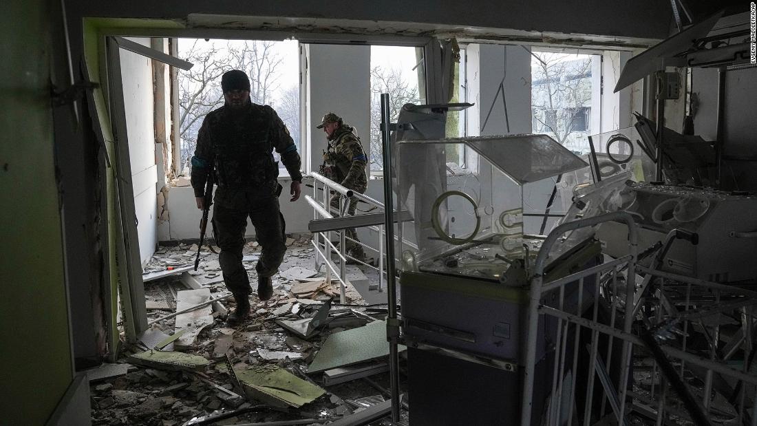 Ukrainian servicemen work inside the damaged hospital.