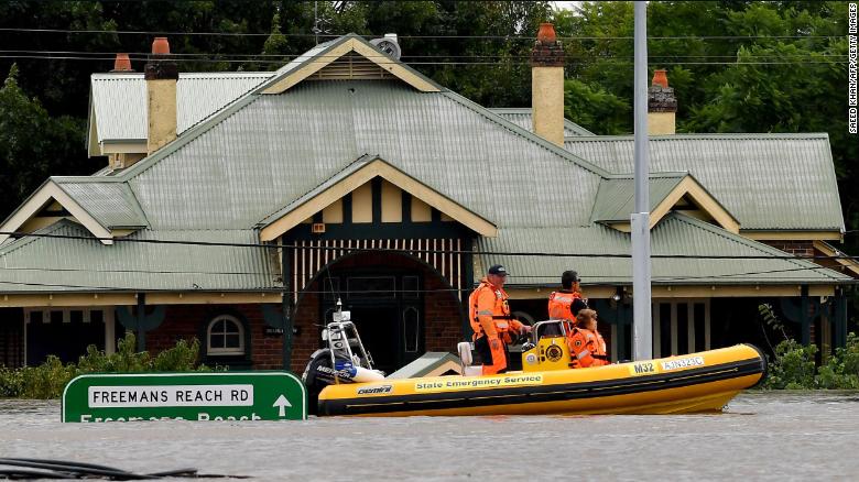 Rescue volunteers patrol around the flooded houses in the Sydney suburb of Windsor, March 9.