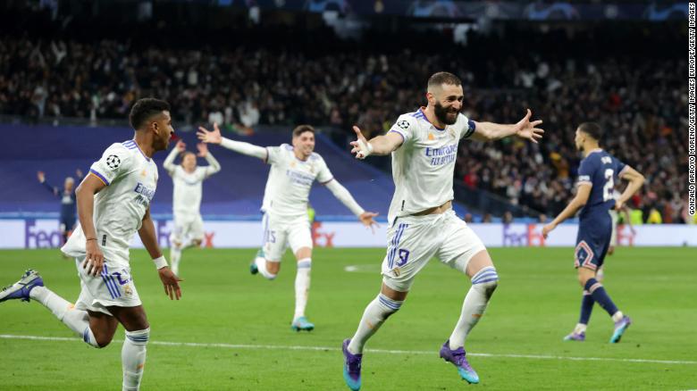 Benzema celebrates with teammates after completing his hat-trick.