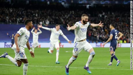 Benzema celebrates with teammates after completing his hat-trick.