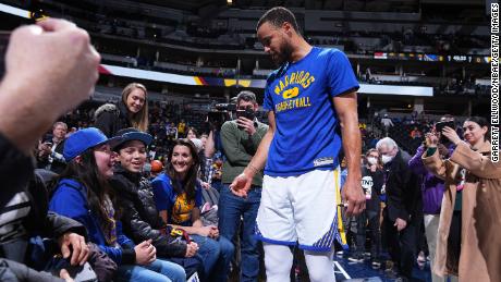 Steph Curry greets young fan, PJ O&#39;Byrne, before the game against the Denver Nuggets in Denver, Colorado.