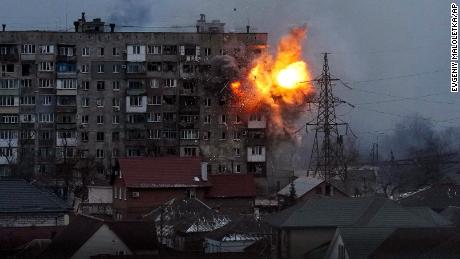 An explosion is seen in an apartment building after Russian&#39;s army tank fires in Mariupol, Ukraine, Friday, March 11, 2022. (AP Photo/Evgeniy Maloletka)