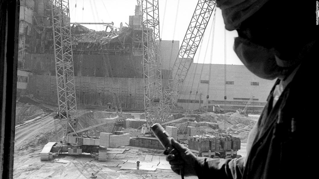 A worker measures radiation levels at the power plant.
