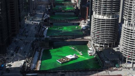 Workers began dyeing the Chicago River Saturday morning. 