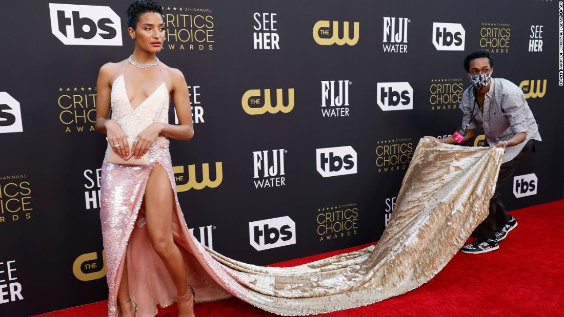 Indya Moore gets some help with her dress while walking the red carpet.