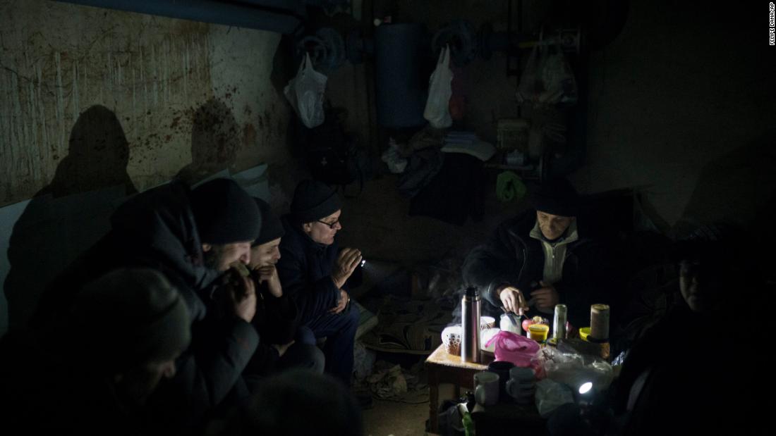 Residents prepare tea as they sit in a basement  in Irpin being used as a bomb shelter on March 13.
