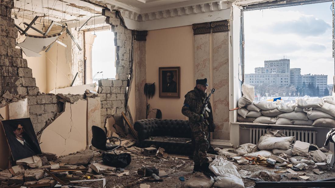 A Ukrainian soldier walks through a destroyed government building in Kharkiv on March 13.