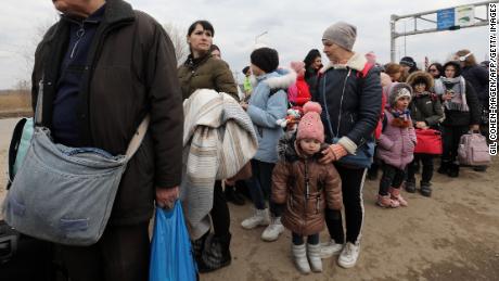 People fleeing the conflict in Ukraine cross the  Moldova-Ukraine border checkpoint near the town of Palanca, on March 14, 2022, after Russia&#39; military invasion of Ukraine. 
