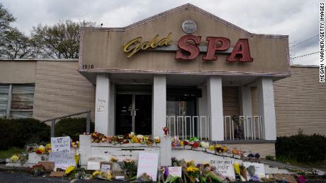 Flowers adorn Gold Spa after a series of shootings at Atlanta-area spas that left eight people, six of them Asian women, dead.