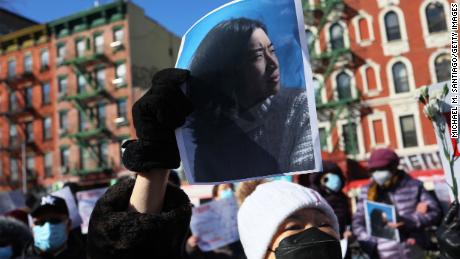 A person holds a photo of Christina Yuna Lee as people gather for a rally protesting violence against Asian-Americans at Sara D. Roosevelt Park on February 14, 2022 in the Chinatown neighborhood in New York City. 