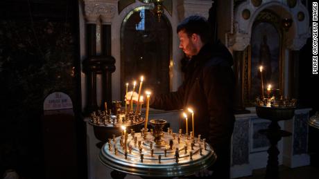A man lights a candle in an Orthodox Church in Kyiv, Ukraine on February 24. 