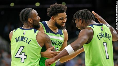 Karl-Anthony Towns receives congratulations from teammates Jaylen Nowell and Anthony Edwards after scoring 60 points against the San Antonio Spurs.