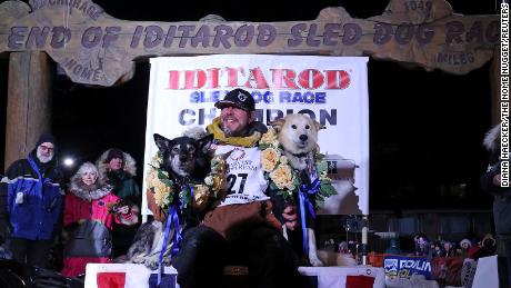 Veteran musher Brent Sass of Eureka, Alaska holds his lead dogs Slater and Morello after winning his first Iditarod Trail Sled Dog Race championship in Nome, Alaska, U.S. March 15, 2022. 