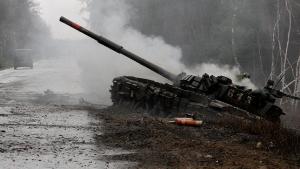 TOPSHOT - Smoke rises from a Russian tank destroyed by the Ukrainian forces on the side of a road in Lugansk region on February 26, 2022. - Russia on February 26 ordered its troops to advance in Ukraine &quot;from all directions&quot; as the Ukrainian capital Kyiv imposed a blanket curfew and officials reported 198 civilian deaths. (Photo by Anatolii Stepanov / AFP) (Photo by ANATOLII STEPANOV/AFP via Getty Images)