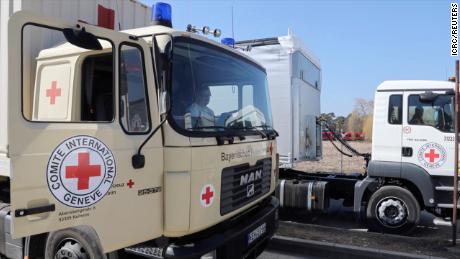 International Committee of the Red Cross trucks wait in line Monday at the Siret border crossing in Romania on their way to deliver aid to Ukraine, in this still image taken from a video.