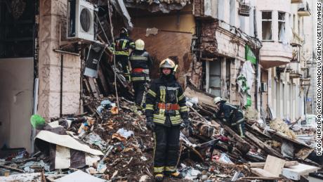 Firefighters work Monday at a building destroyed by a Russian shell in Kharkov, Ukraine.