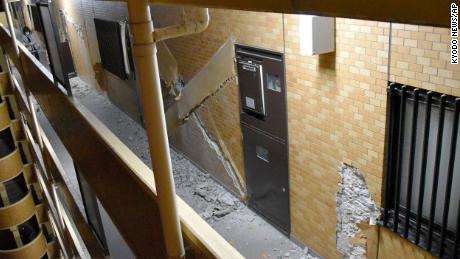 Cracked walls are found in an apartment building in Fukushima after Wednesday's quake.