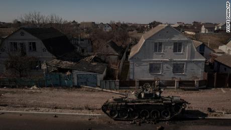 A destroyed tank sits on a street after battles between Ukrainian and Russian forces on a main road near Brovary, north of Kyiv, Ukraine, Thursday, March 10, 2022.